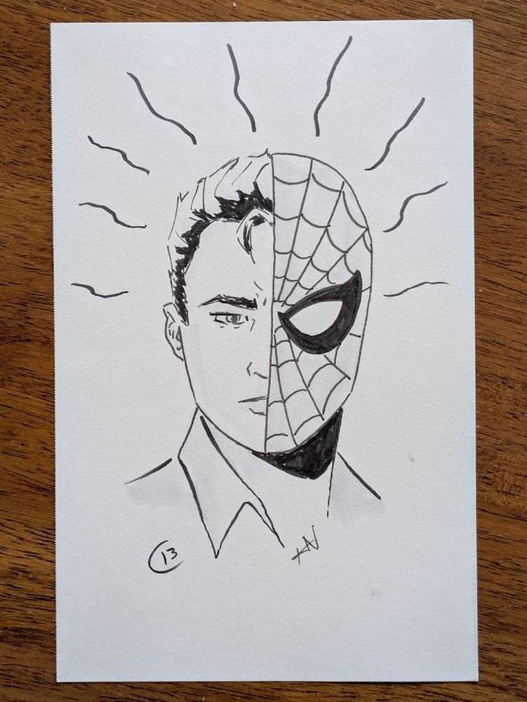 A photograph of a black and white, pencil and ink sketch of Peter Parker / Spider-Man showing his two identities with wavy lining dancing around his head to show his Spider-Sense.
