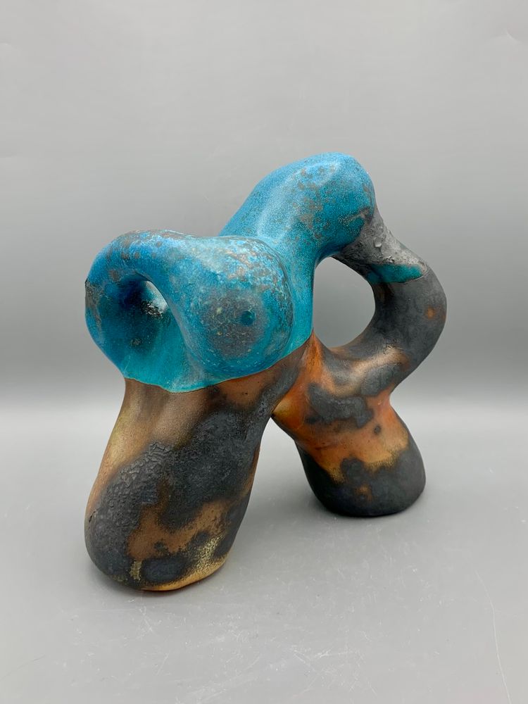 A black, brown, and blue ceramic sculpture