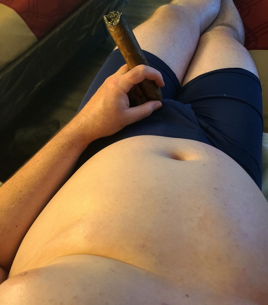 A POV shot of El Dad, looking down at his gut while he's enjoying a cigar