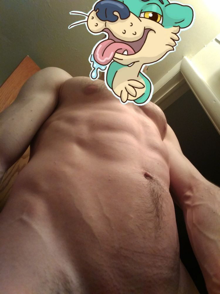 A low shot of El Dad from groin height, showing a very lean physique. There are abs and veins on the lower torso