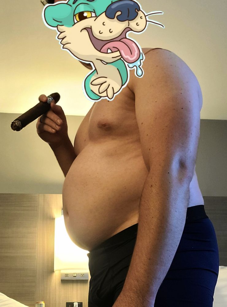 A photo of El Dad, now only in underwear, low angle, holding a large cigar.
