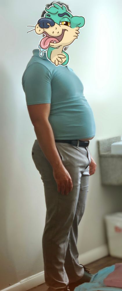 A photo of El Dad in a too-tight baby blue polo shirt and tight grey slacks. It's a full body shot from the side.
