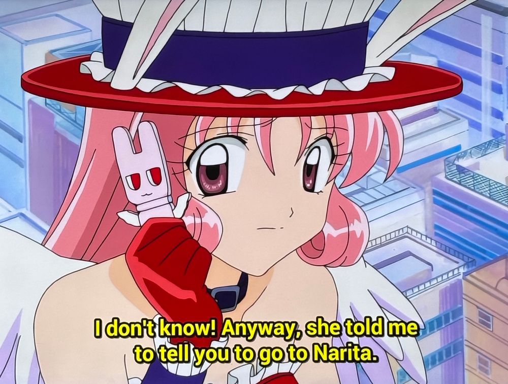 A screenshot from Full Moon Wo Sagashite, with the character Meroko holding a cell phone that looks like her mascot form. 