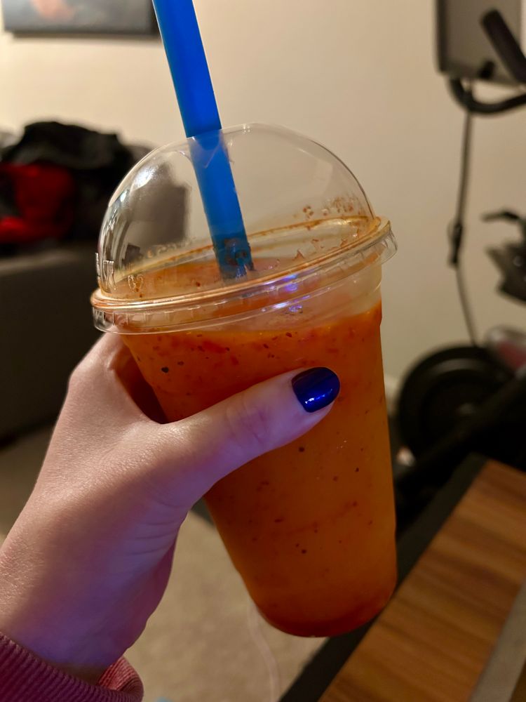 A mangonada with blue straw 