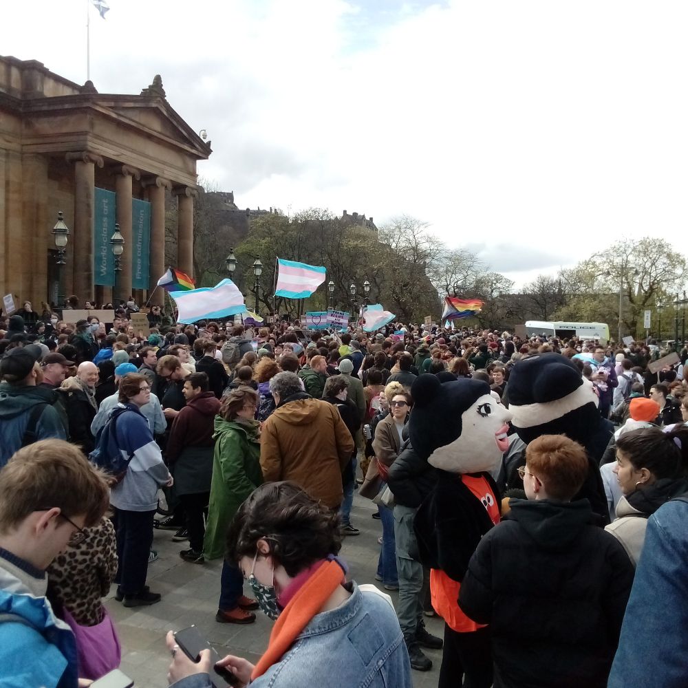 People gathered at the foot of the mound in Edinburgh to support trans rights, trans pride and progress pride flags being waved.
