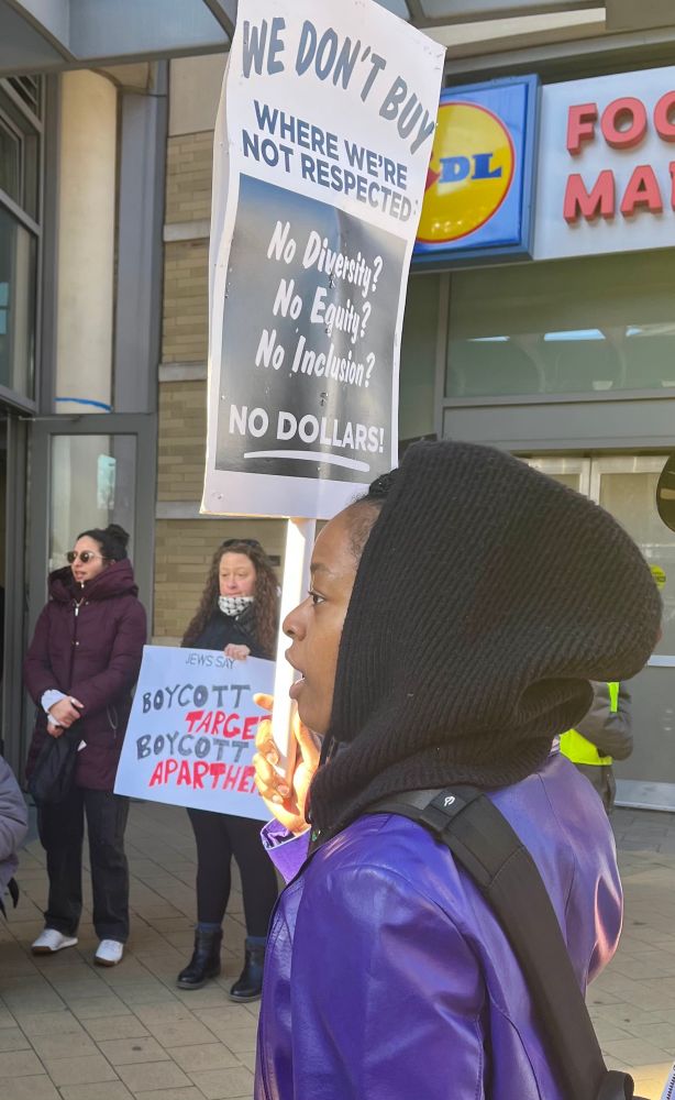 Protestor holding sign for DEI