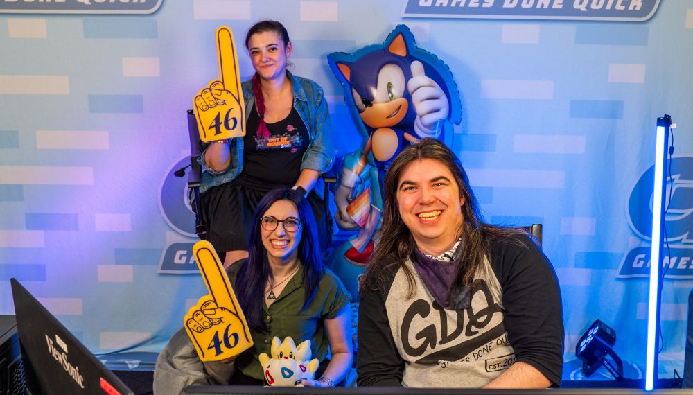 A group photo of Burtch, Metroid Crime and Jaidlyn on the "couch" for the Blue Prince run. A large Sonic the Hedgehog balloon is also there.