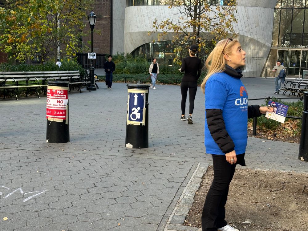 Mario Cuomo campaigner electioneering right in front of polling location “No Electioneering” sign.