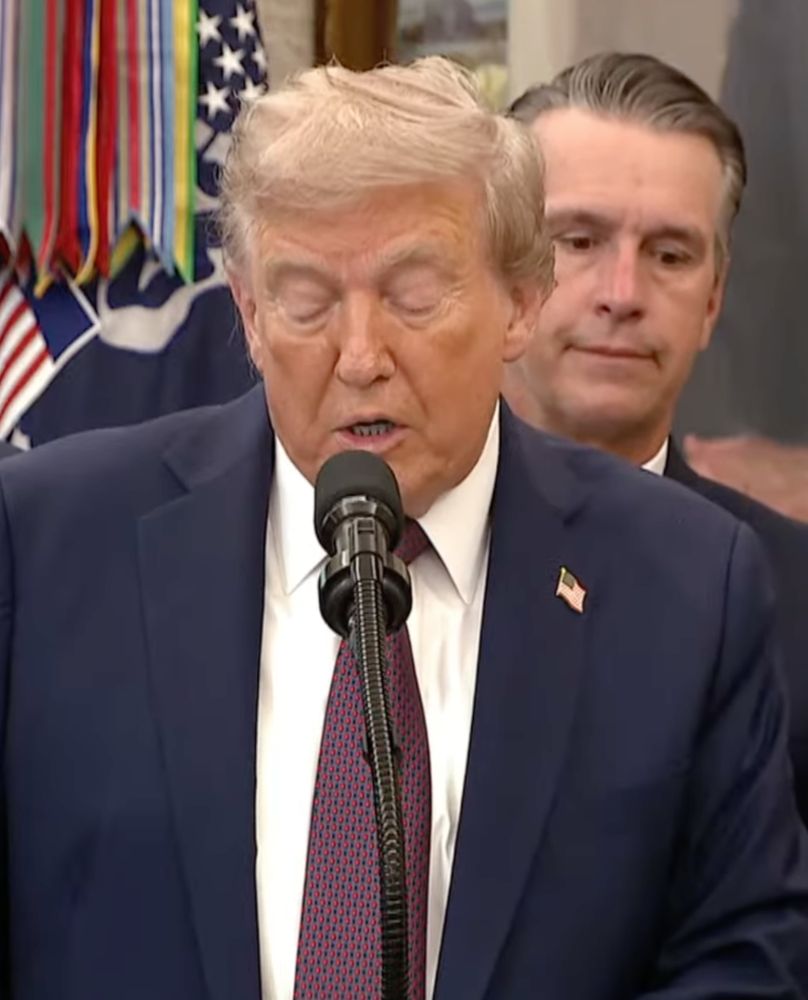 Screen cap of the 'proof of life' press conference. Note the pronounced lines on his nose and the weird puffy mask around Trump's eyes.