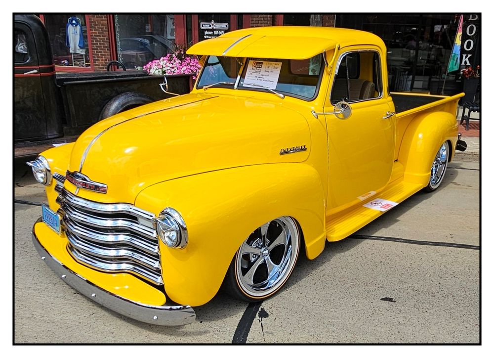 A yellow 1950 Chevy 3100 pickup on display at the 2025 Hub City Car Show in Marshfield, Wisconsin.
