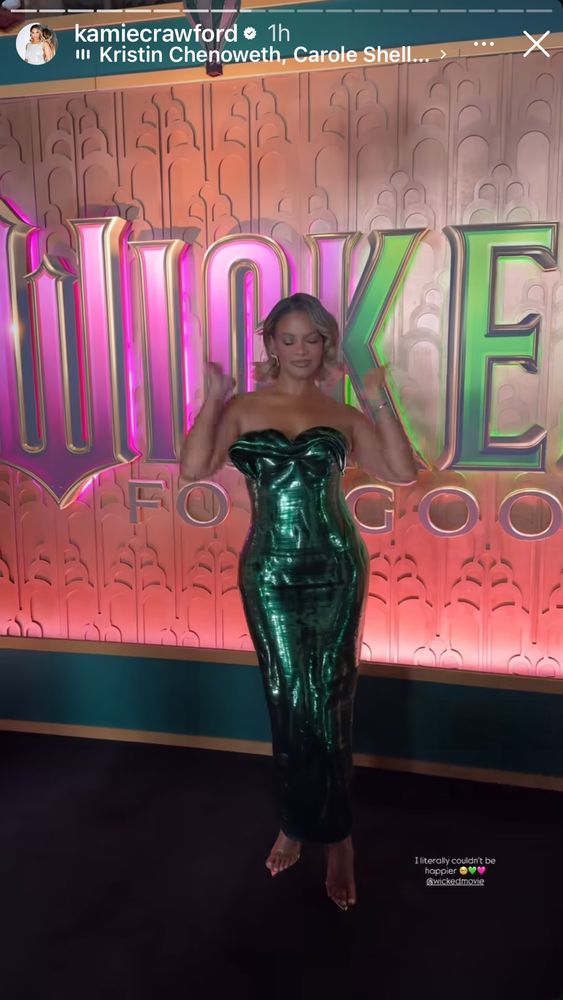 Content creator Kamie Crawford with a blonde wavy bob in a strapless green metallic dress. On the carpet for the premiere of wicked. 