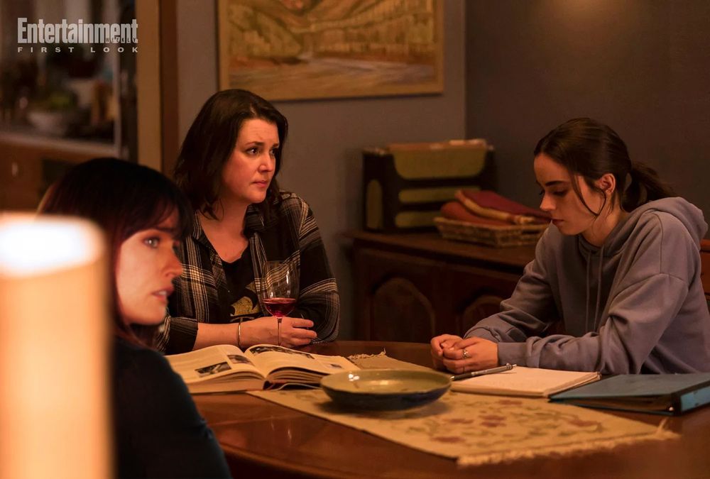 jackie, shauna, and callie sitting at a table in a yellowjackets s3 photo