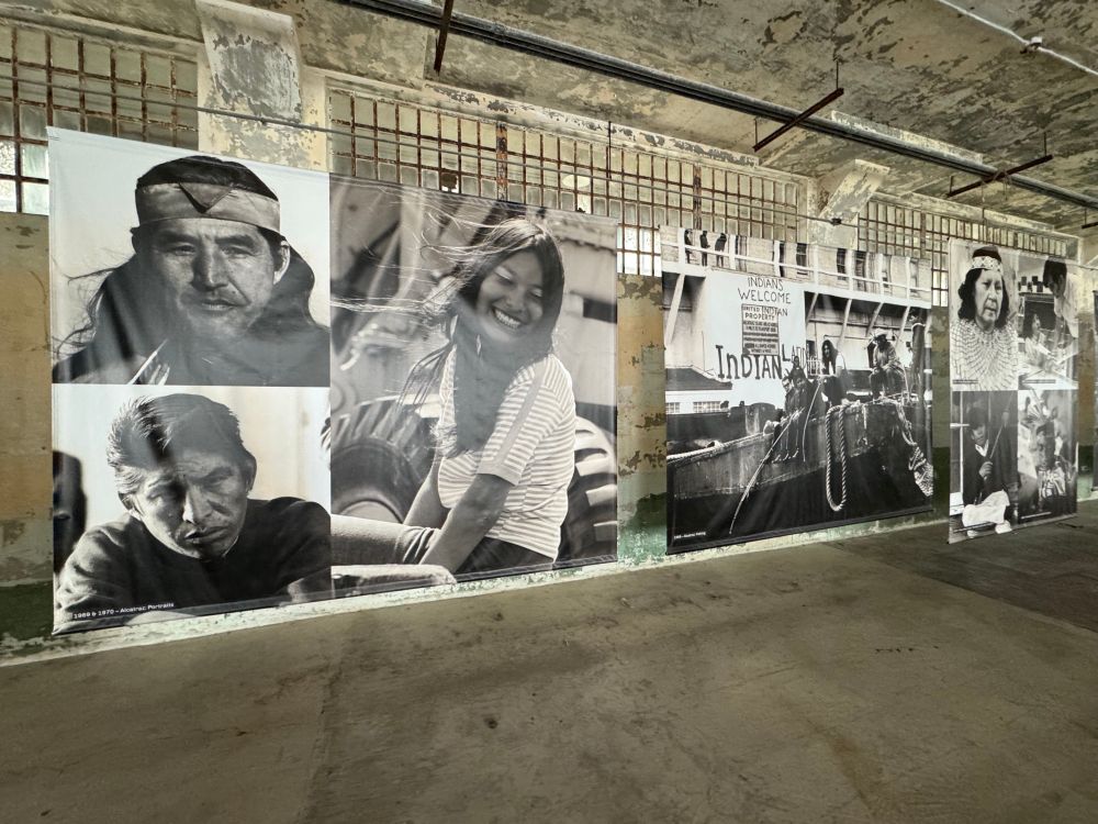 Montage of black and white photos inside the exhibit-printed on large banners-of people who were part of the Alcatraz occupation 