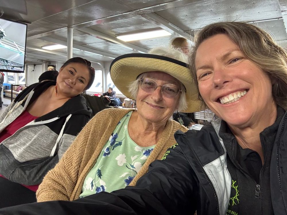 Selfie of Laurie Morales, Beverly Oritz, Shannon Tushingham, sitting next to each other and smiling