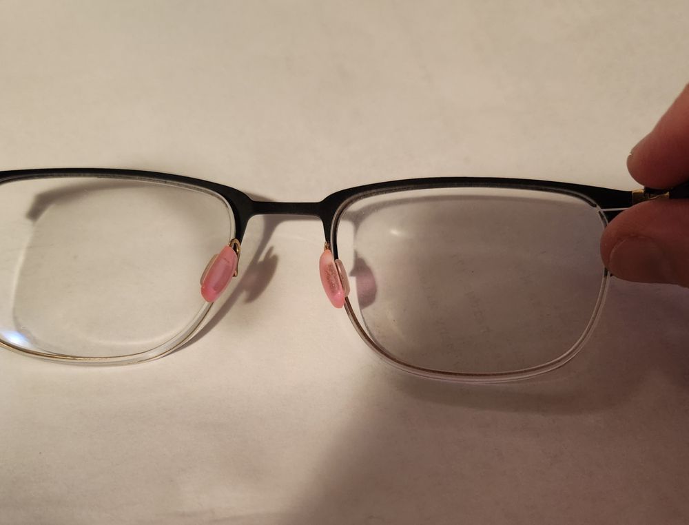 Glasses with light red, almost pink noseguards.