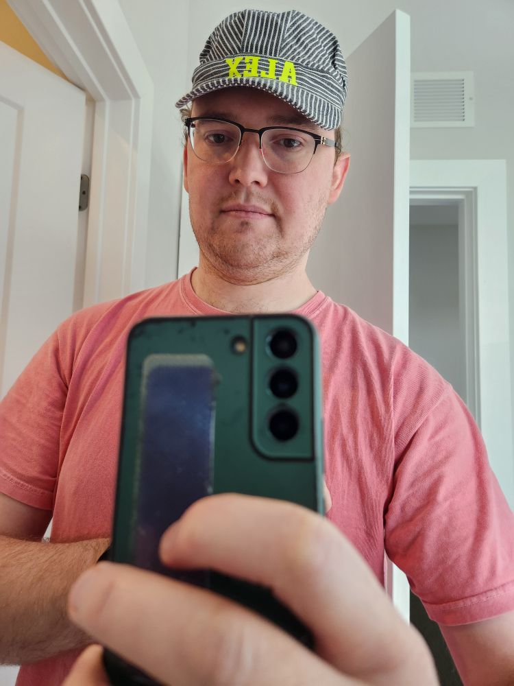 Alex in a train conductor hat 