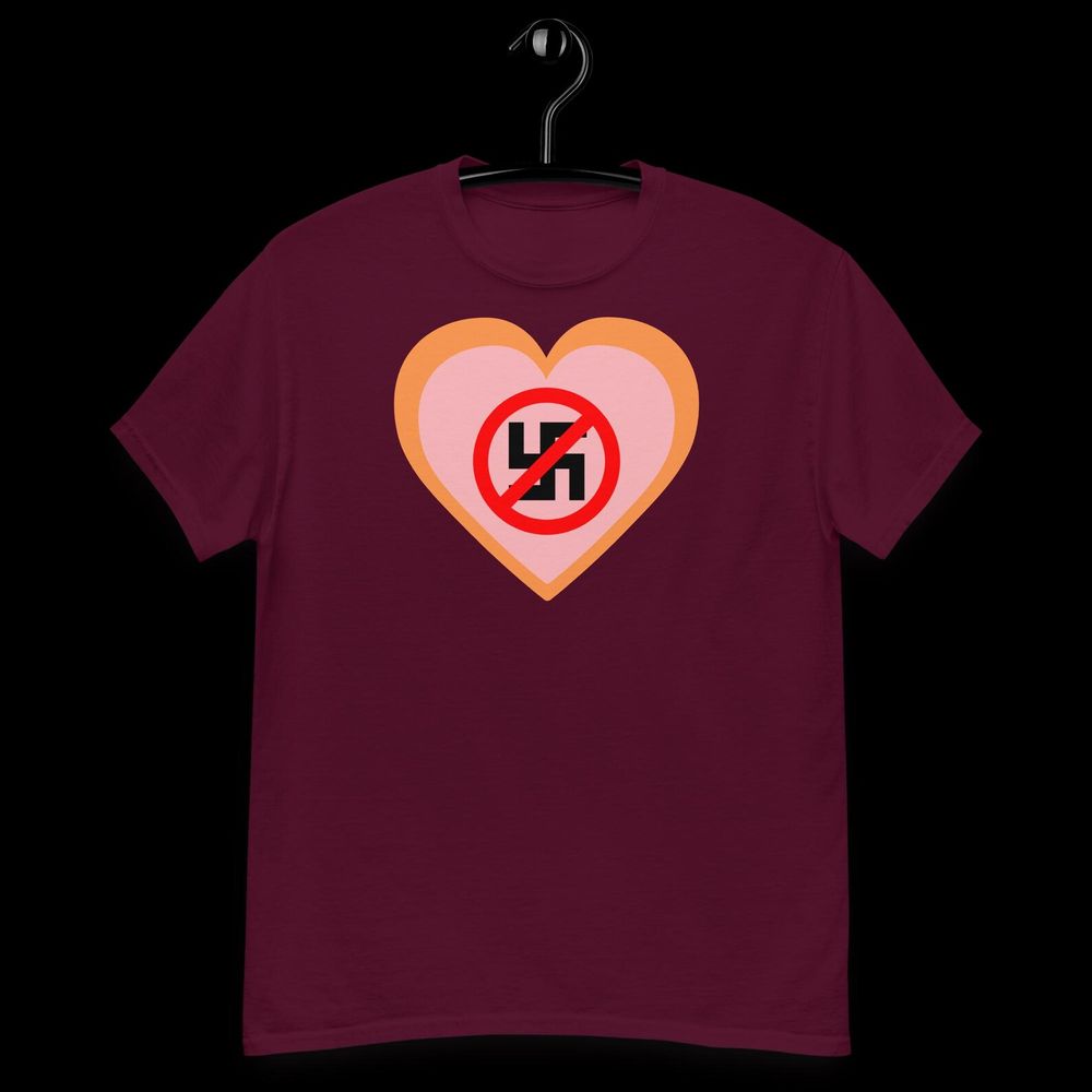 maroon t-shirt with a heart shape, within is a no to nazis symbol