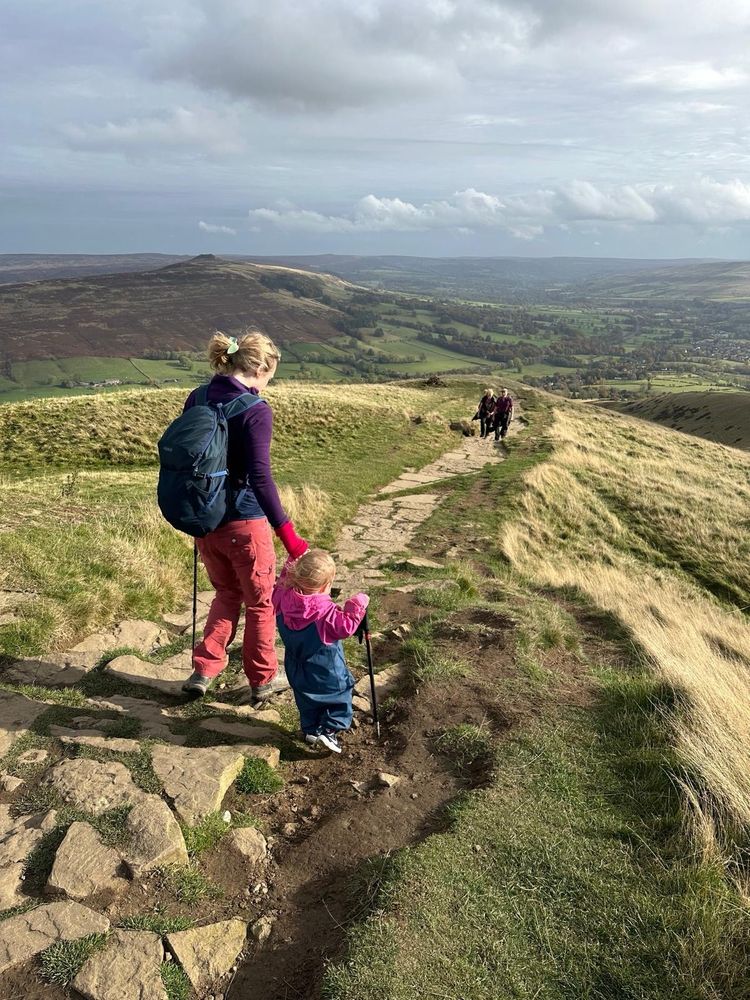 Photo of Jade walking down Lose Hill with her 2 year old daughter. 
