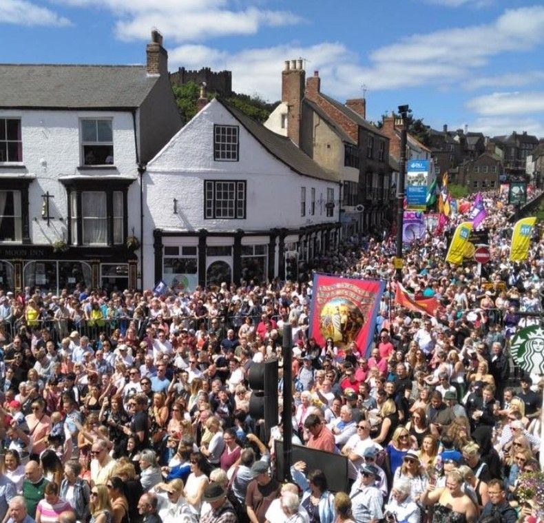 Image shows the Durham Miners' Gala thronging the city streets.