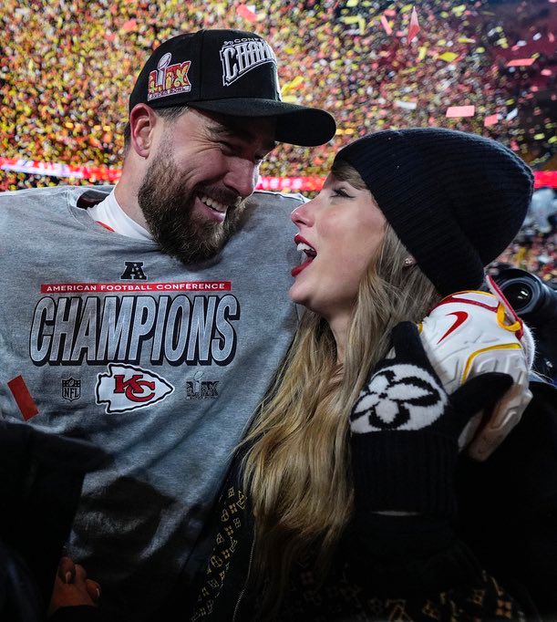 Travis Kelce and Taylor Swift hugging and smiling at each other after the Chiefs beat the Bills.