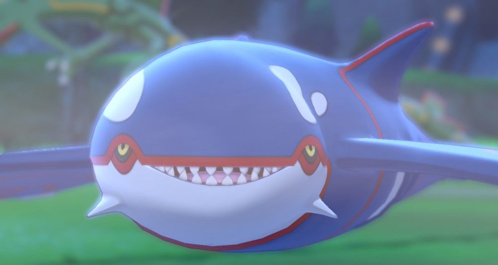 Screenshot of kyogre looking at the player character in Pokémon camp smiling 