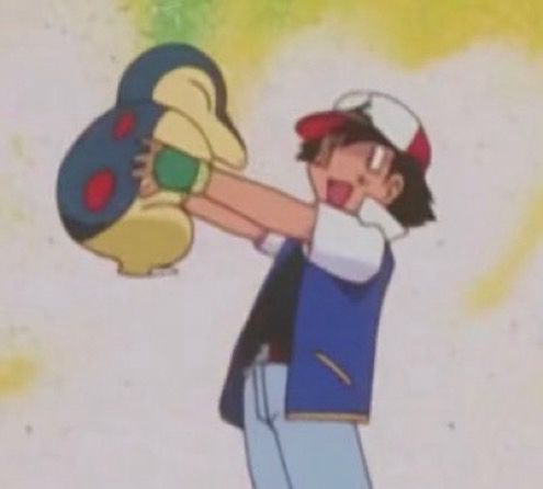 Screenshot of Ash holding up Cyndaquil in the Pokémon anime 