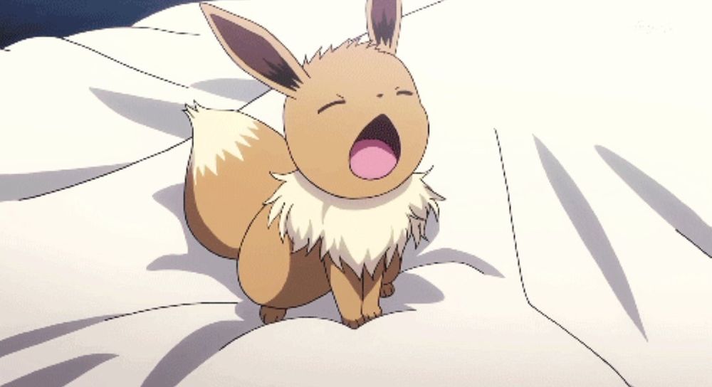 Screenshot of Eevee on a bed yawning in the Pokémon anime 