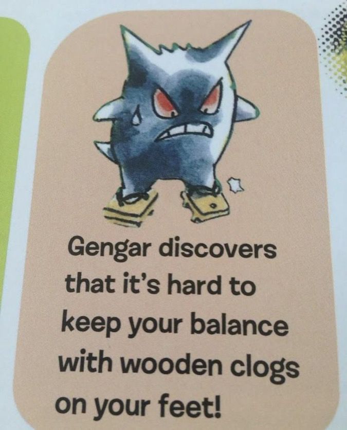 Photo of a Gengar in a picture book with wooden clogs on its feet with text saying “Gengar discovers that it’s hard to keep your balance with wooden clogs on your feet!”