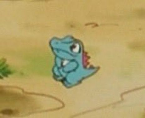 Screenshot of a zoomed in screenshot of a tiny Totodile in the Pokémon anime 