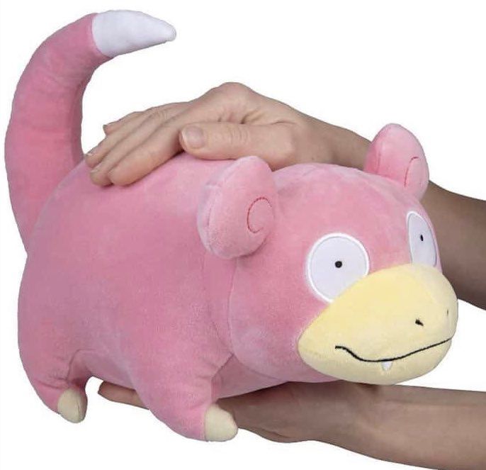 Picture of a persona holding a slowpoke plush in a promotional picture 