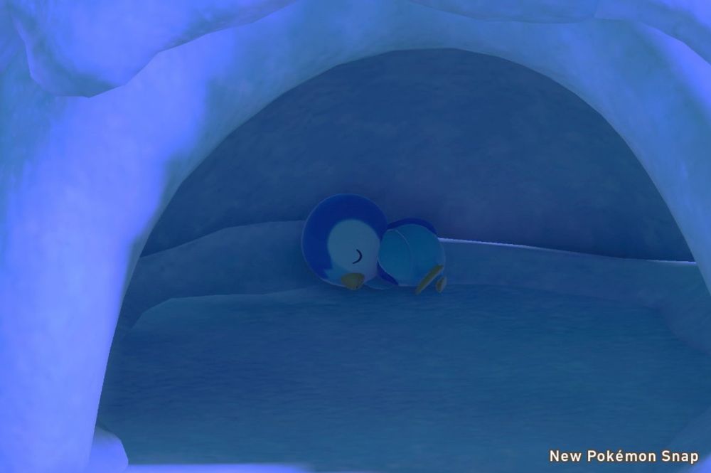 Screenshot of a piplup sleeping in an ice cave in new Pokémon snap 