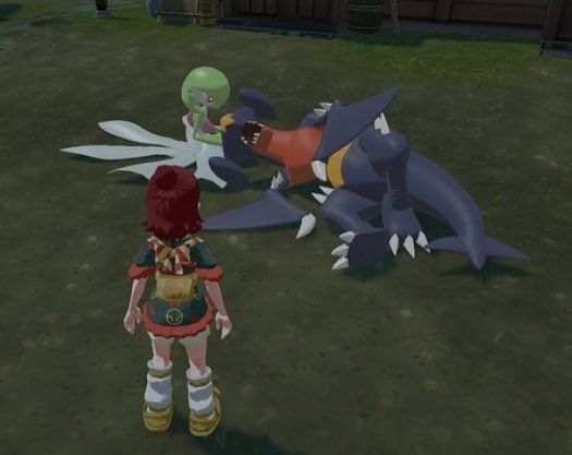 Screenshot of Pokémon legends Arceus showing a Garchomp sleeping on a Gardevoirs lap 
