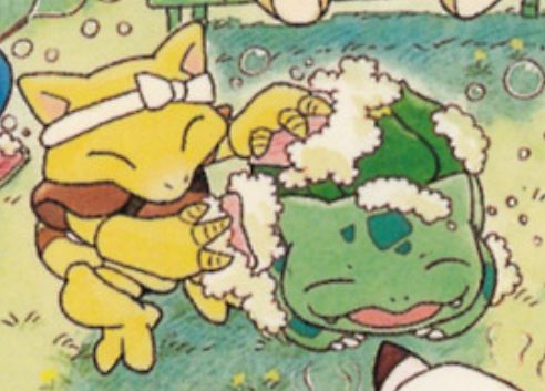 Photo of an abra giving a bulbasaur a bath on a grassy field 