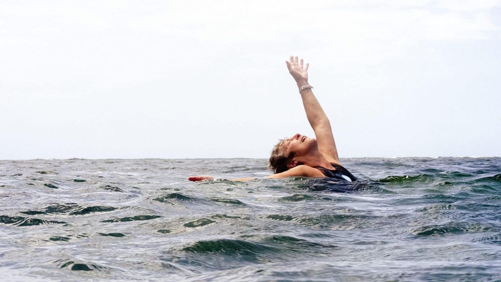Brenda Laurel swimming in Hawaii and reaching for the sky.