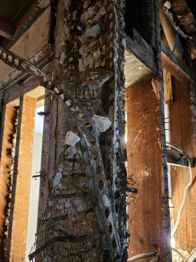 warped metal peeling off a corner stud