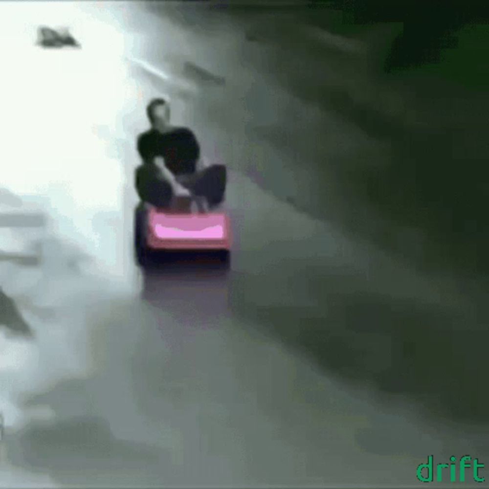 a man is riding a pink lawn mower with the word drift on the bottom