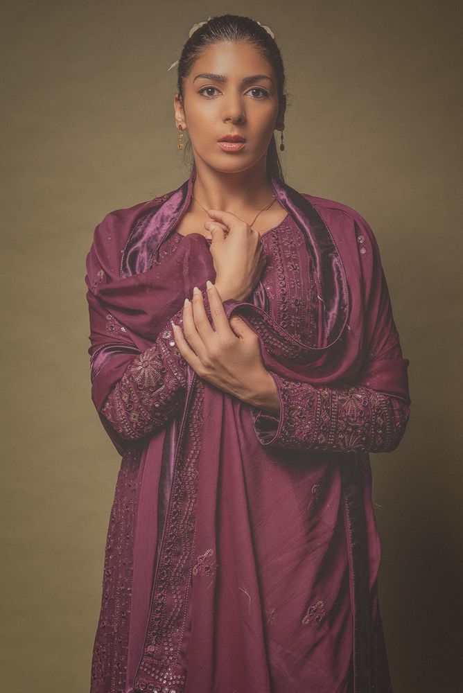 Beautiful lady in Shalwar Kameez shot against a green paper backdrop with a single light. 