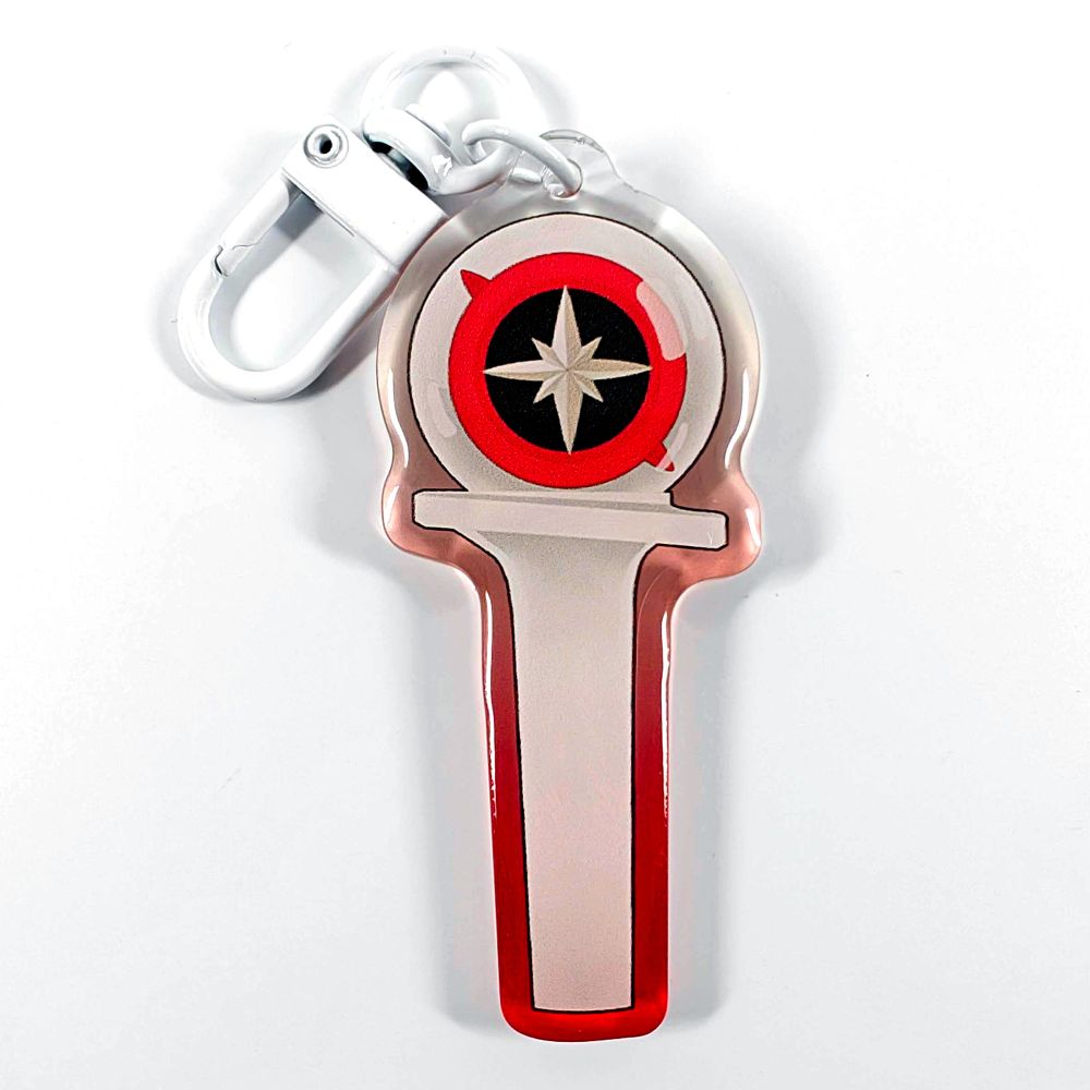 A picture of an acrylic keychain of a drawn version of Stray Kids' newest lightstick. The rim of the keychain has an ombre that goes from red at the bottom to clear at the top. It has a white clasp.