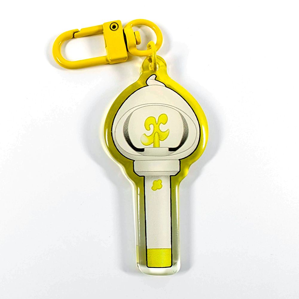 A picture of an acrylic keychain of a drawn version of Xikers' newest lightstick. The rim of the keychain has an ombre that goes from clear at the bottom to yellow at the top. It has a bright yellow clasp.