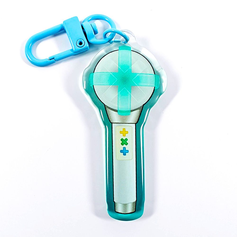 A picture of an acrylic keychain of a drawn version of TXT's newest lightstick. The rim of the keychain has an ombre that goes from teal at the bottom to clear at the top. It has a light blue clasp.