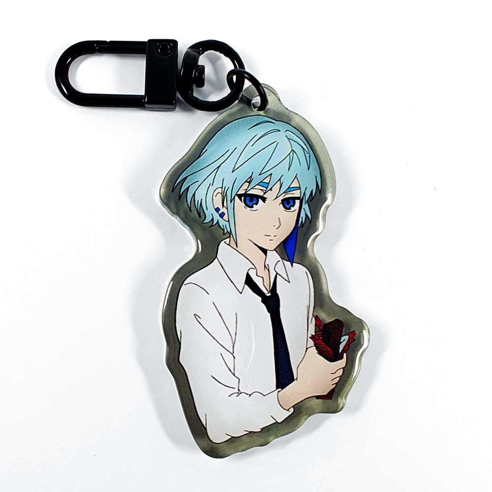 A picture of an acrylic keychain of Khun from Tower of God. He is smiling, holding a chocolate bar and wearing his classic outfit from season 1. The rim of the keychain is translucent grey. It has a black clasp.