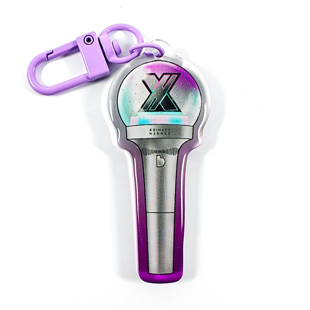 A picture of an acrylic keychain of a drawn version of Xdinary Heroes' newest lightstick. The rim of the keychain has an ombre that goes from purple at the bottom to clear at the top. It has a light purple clasp.