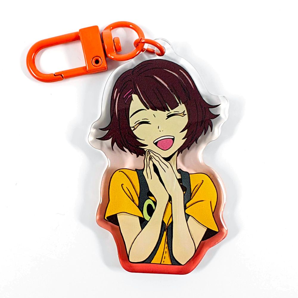 A picture of an acrylic keychain of Endorsi from Tower of God. She is smiling wide, clasping her hand together and wearing her classic outfit. The rim of the keychain is a gradient going from orange at the bottom to clear at the top. It has a bright orange clasp.