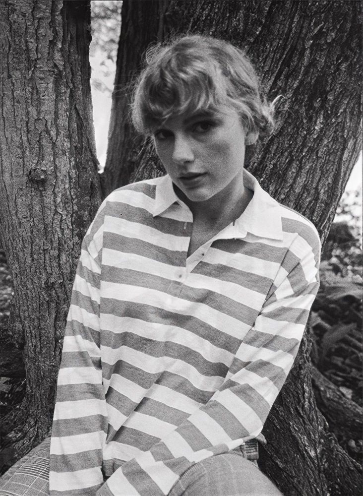 A black and white picture of taylor swift staring at the camera. 