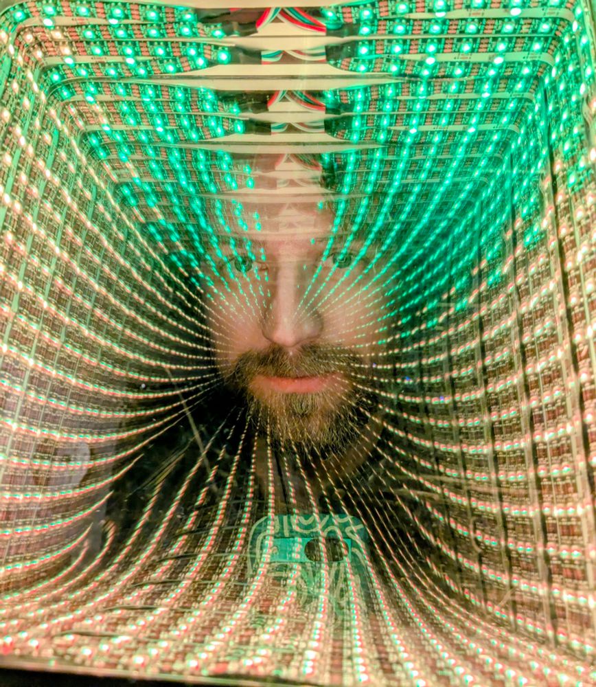 Photo of the mirror, with a ghosted image of camera and photographer. 