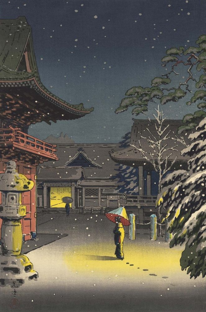 A person walks through the shrine grounds at night holding an umbrella and leaving footprints in the snow. It is lightly snowing.