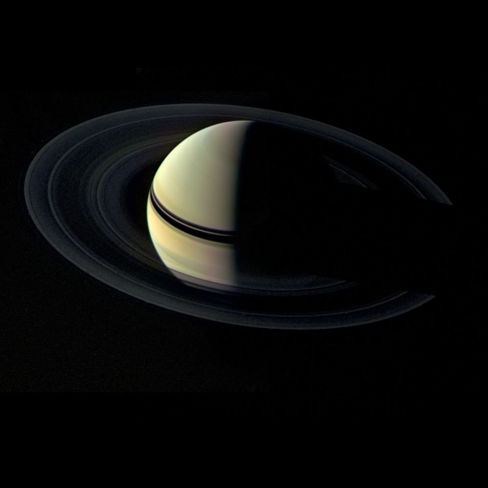 A crescent Saturn and dark rings. 