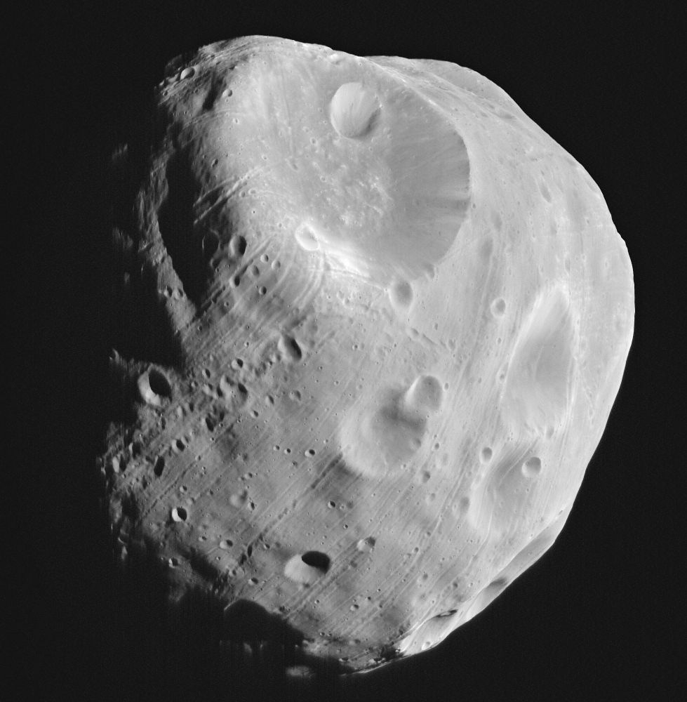 The fractured, cratered surface of Phobos, moon of Mars.