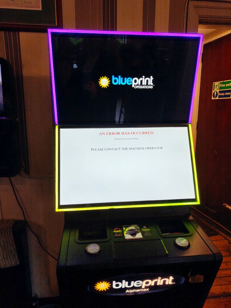 A jukebox or games machine showing an error message: "AN ERROR HAS OCCURRED PLEASE CONTACT THE MACHINE OPERATOR"