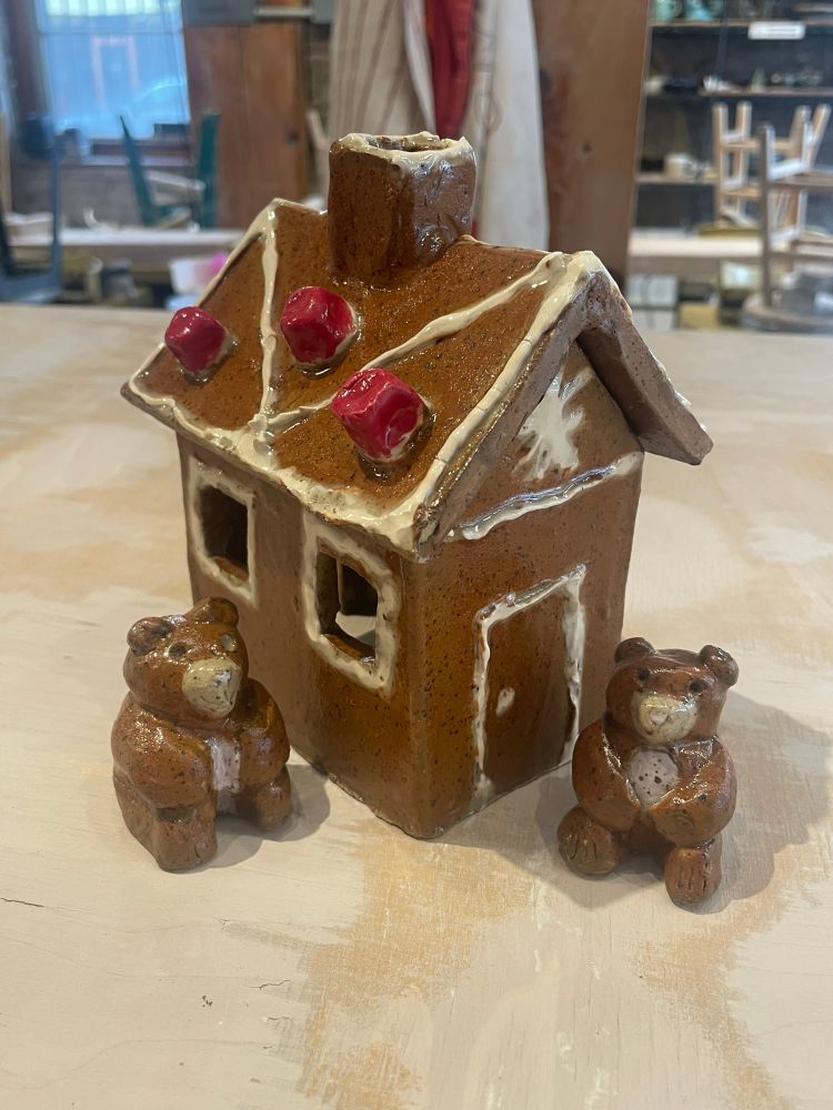 Ceramic gingerbread house with little ceramic teddy bears